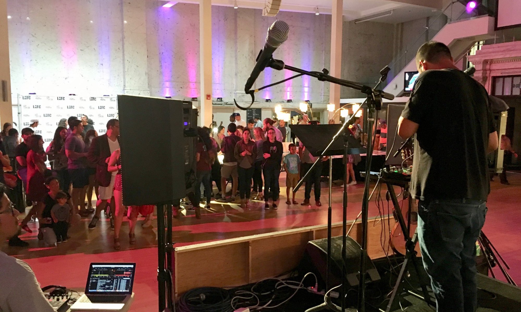 The view from the stage. A singer adjusts the microphone.